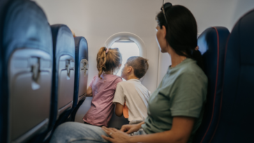 Mother flying with two young children on airline