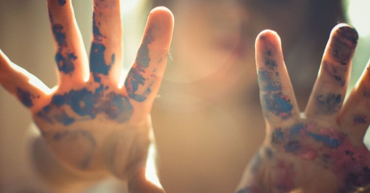 Toddlers hands covered in paint