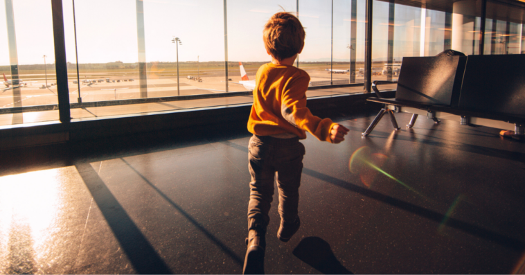 young boy running in airport