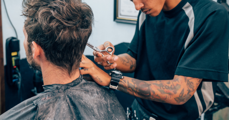 barber cuts a customer's hair