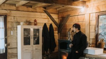 man in rustic cabin