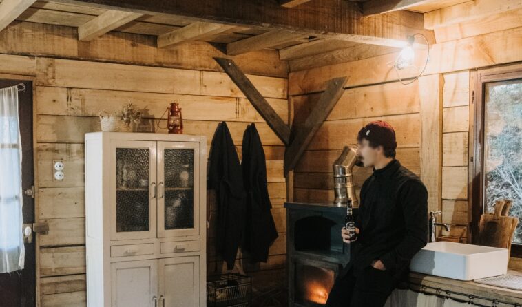 man in rustic cabin