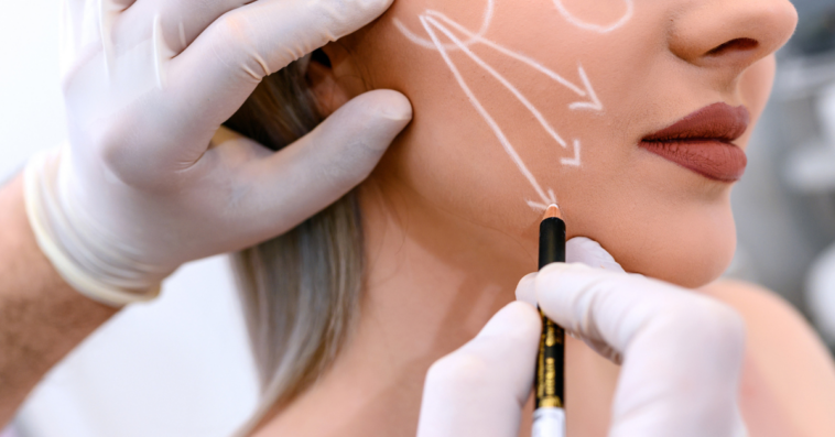 A young woman marked up for plastic surgery