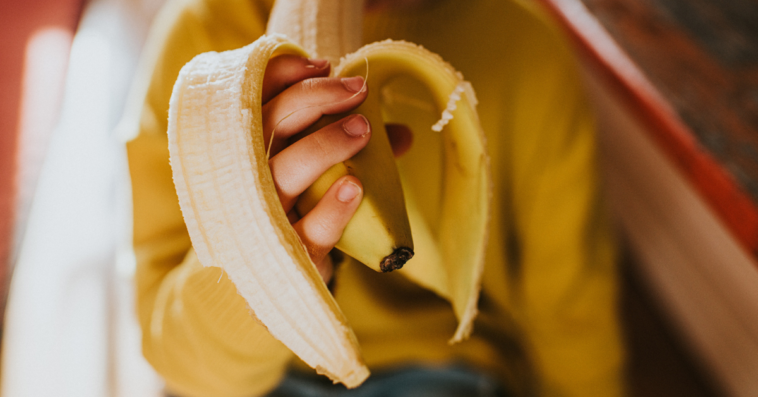 Girl eating a banana