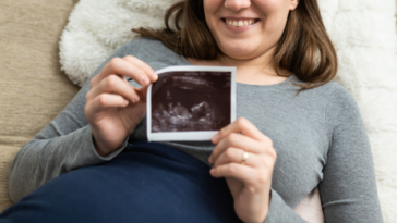 Woman holding ultrasound photo