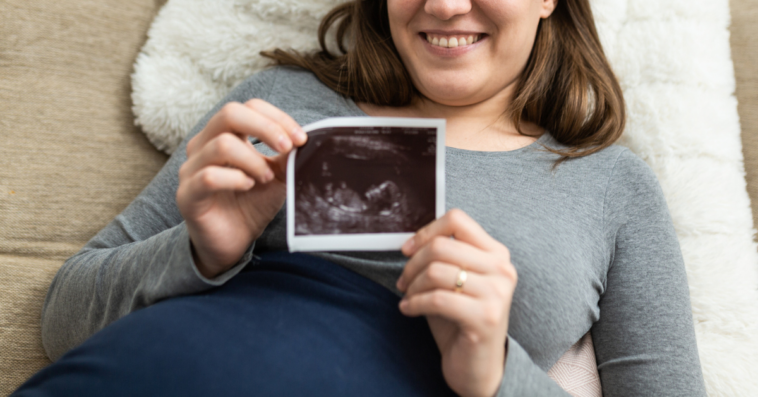 Woman holding ultrasound photo