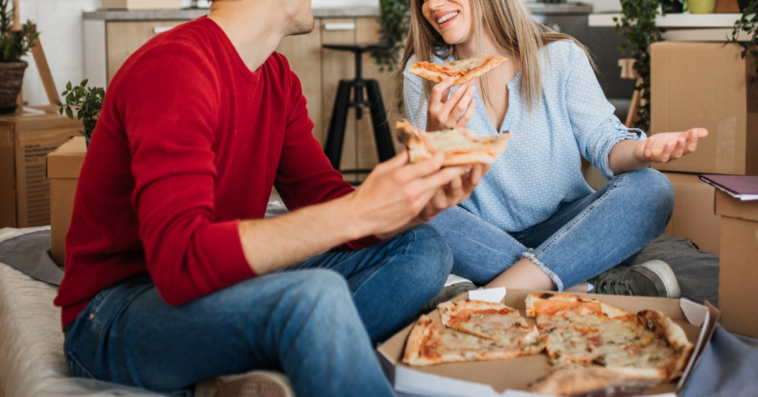 two people eating delivery pizza together