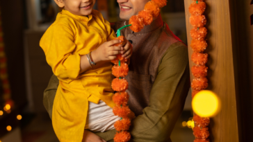 Hindu man holding his son