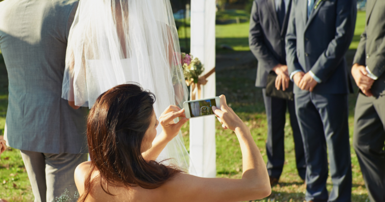Woman taking photos during wedding ceremony