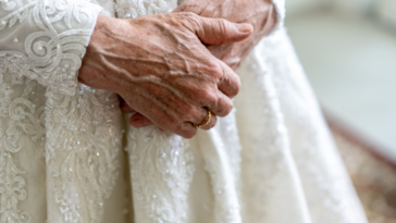 Elderly bride with her hands clasped.
