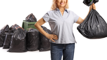 Older woman with a lot of black trash bags after decluttering