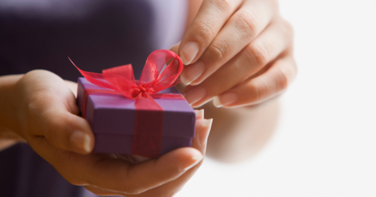 Woman opening a small box.