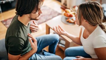 Couple having relationship issues, arguing and fighting in living room