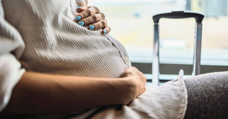 pregnant woman seated in an airport