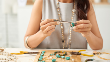 Woman making jewelry for her small business