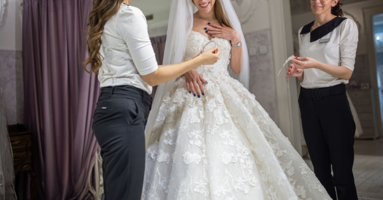 Bride trying on wedding dresses