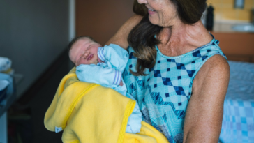 grandmother holding newborn baby