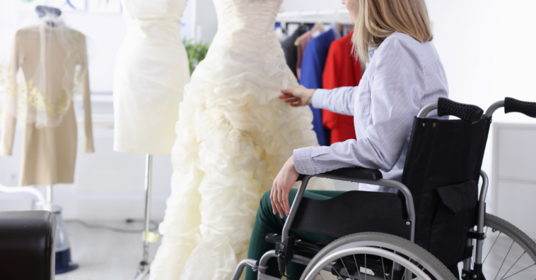 woman in wheelchair looks at wedding dress