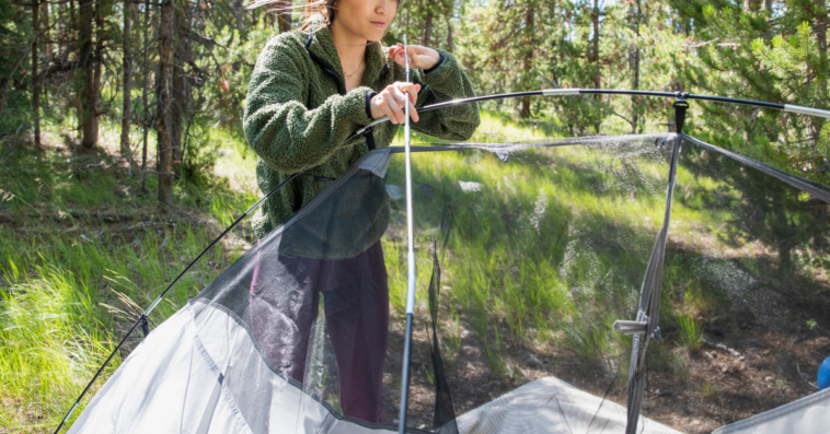 Woman setting up tent