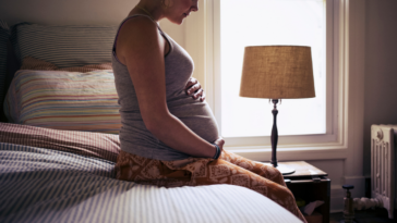Pregnant woman in bedroom