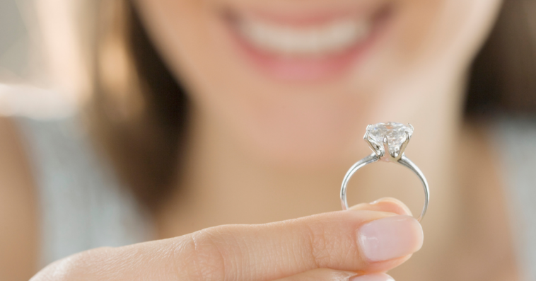 Woman holding an engagement ring.