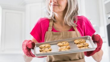 Portrait of Caucasian woman holding baked cookies