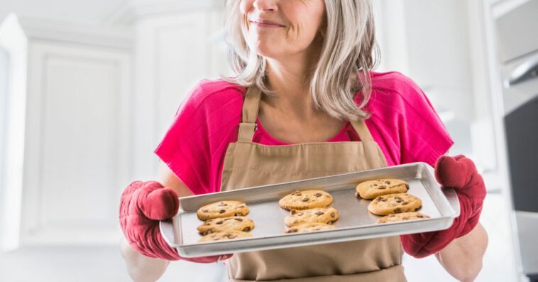 Portrait of Caucasian woman holding baked cookies