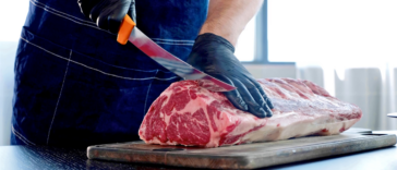 guy cutting meat with knife