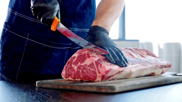 guy cutting meat with knife