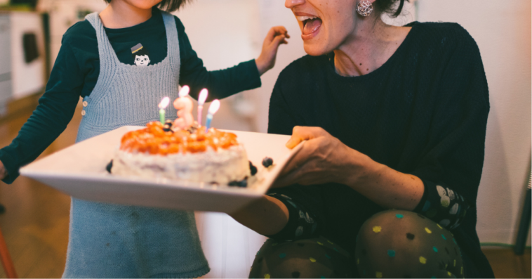 little girl and woman with birthday cake
