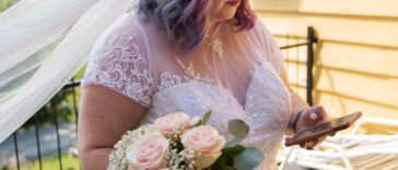 Body positive future bride with mobile phone before wedding.
