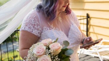 Body positive future bride with mobile phone before wedding.