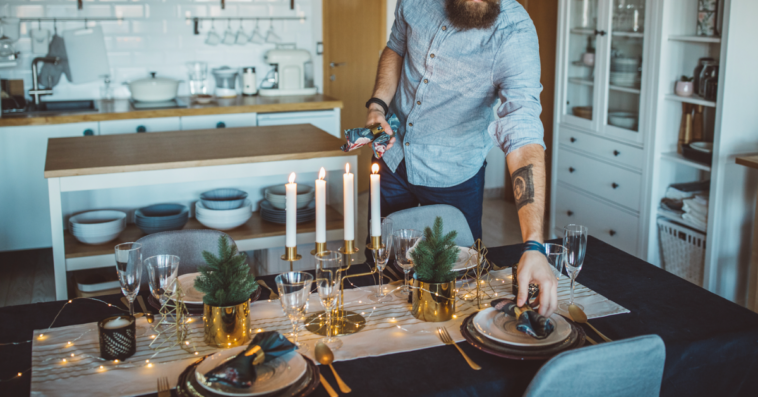 A man setting the table.