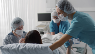 Laboring woman surrounded by medical team