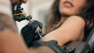A woman getting a tattoo.