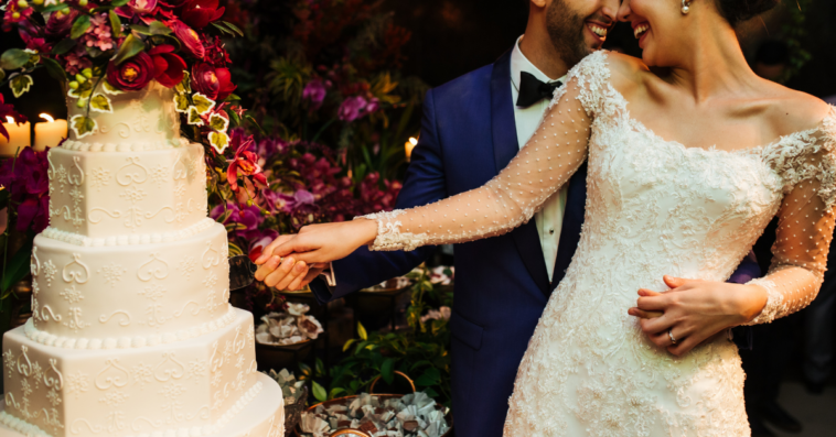 bride and groom cut the cake at a wedding reception