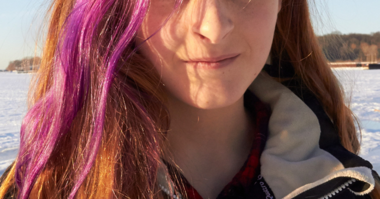 young woman with pink streak in her hair