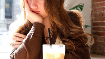 unhappy teen girl in restaurant