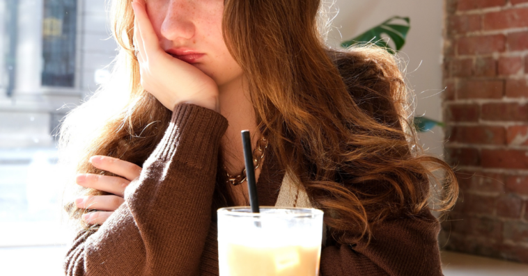 unhappy teen girl in restaurant
