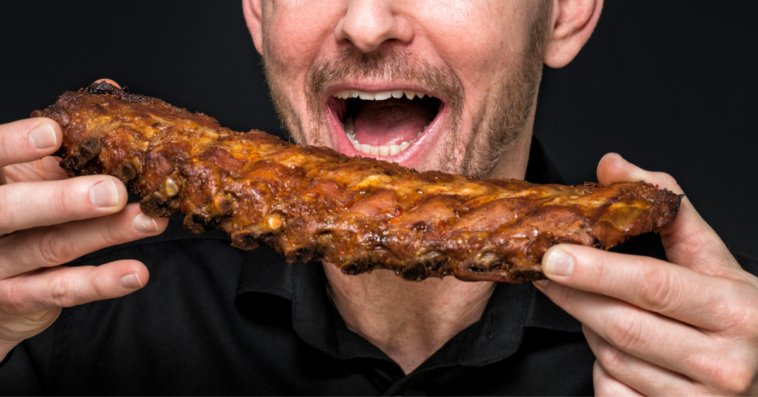 man eating rack of ribs
