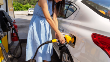 woman filling her car with gas