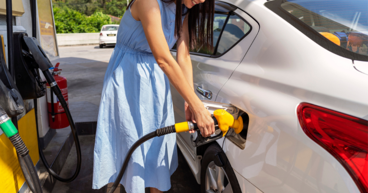 woman filling her car with gas