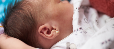 baby with ear piercing