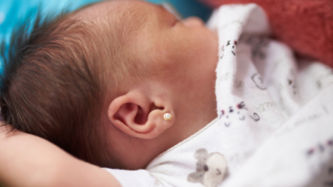 baby with ear piercing