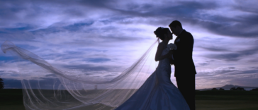 A silhouette of a bride and groom.