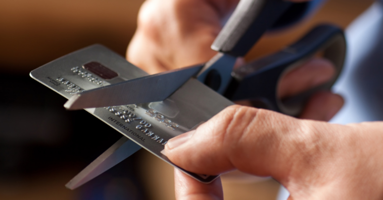 Man cutting up a credit card