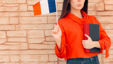 A young woman holding a French flag.