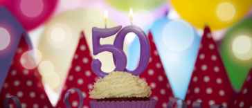 A cupcake with 50th birthday candles.