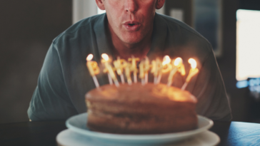 Man blowing out candles