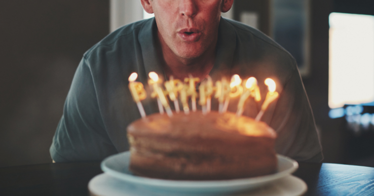 Man blowing out candles